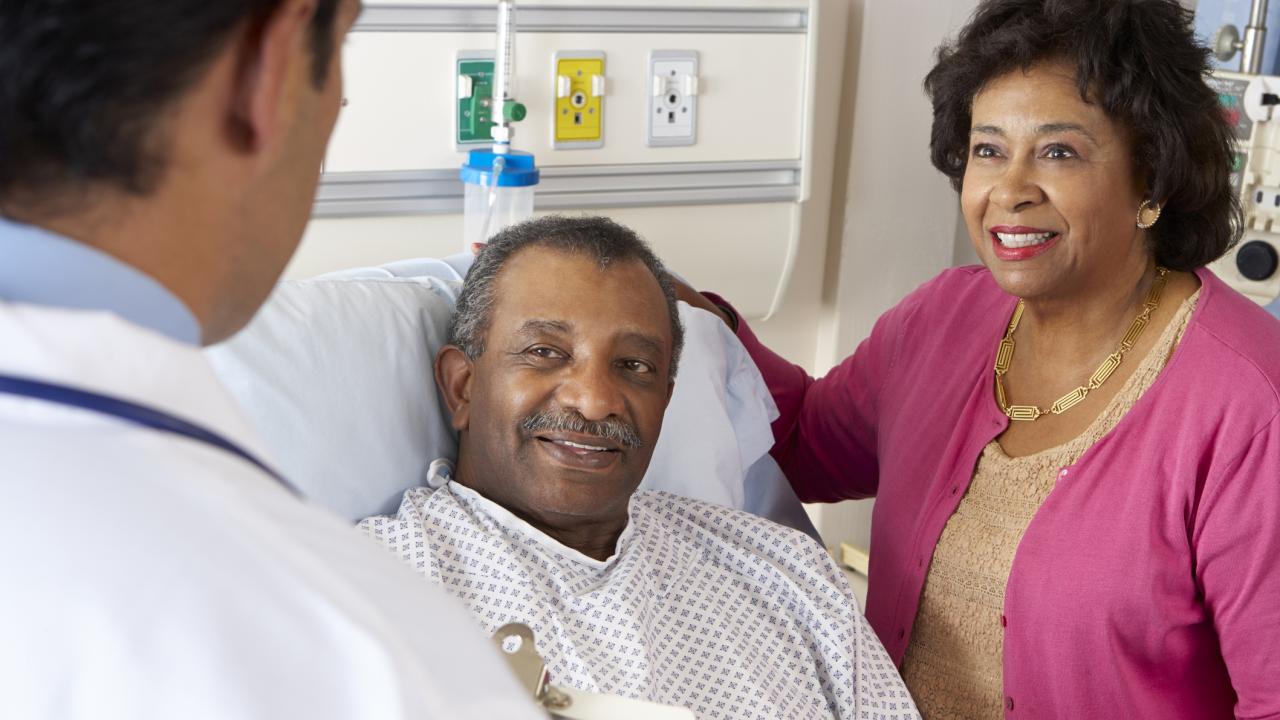 Doctor Explaining Procedure To Patient and Spouse